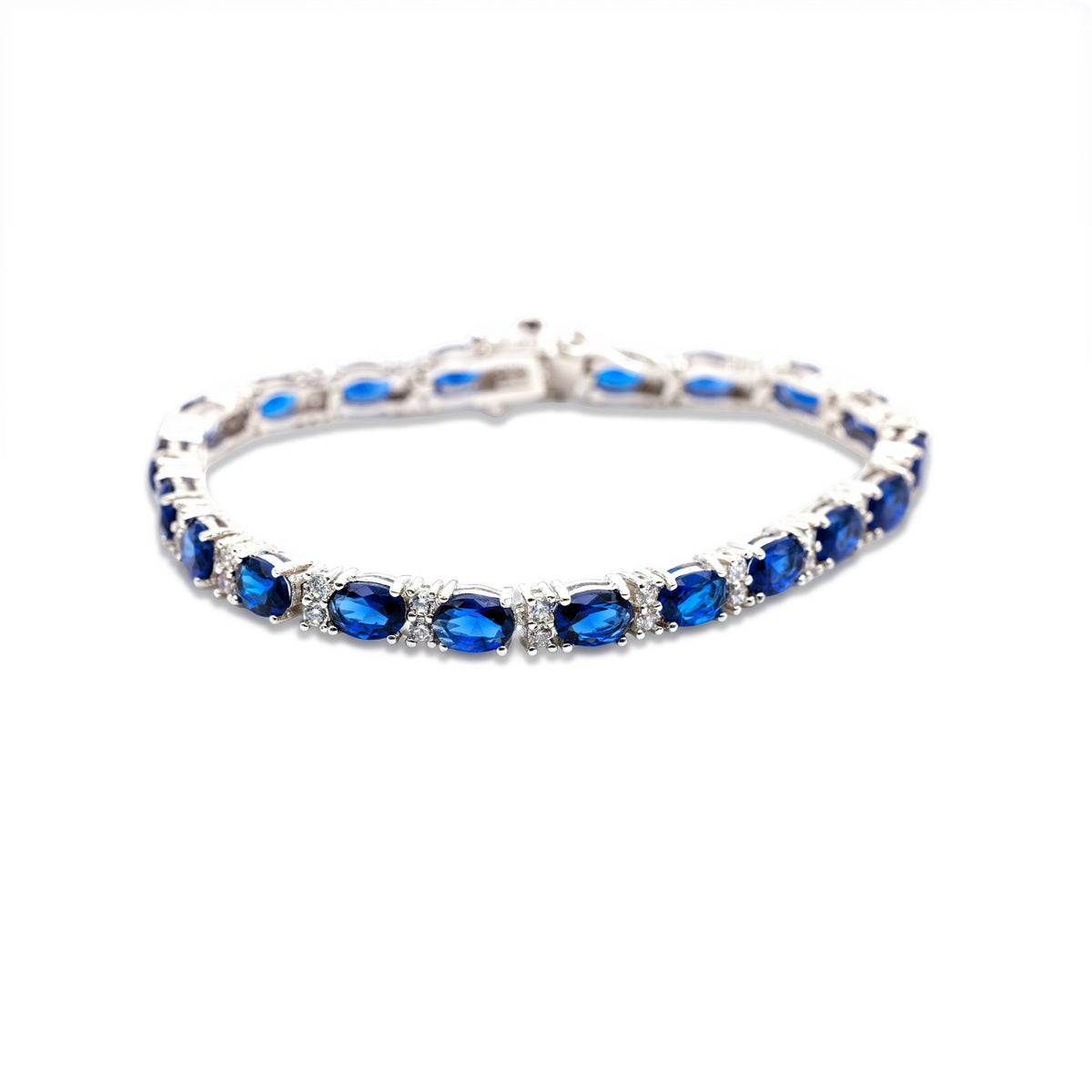 Saphirblaues Tennisarmband mit facettierten Ovalsteinen und Zirkonia-Akzenten in silberfarbener Fassung von Avirelle.
